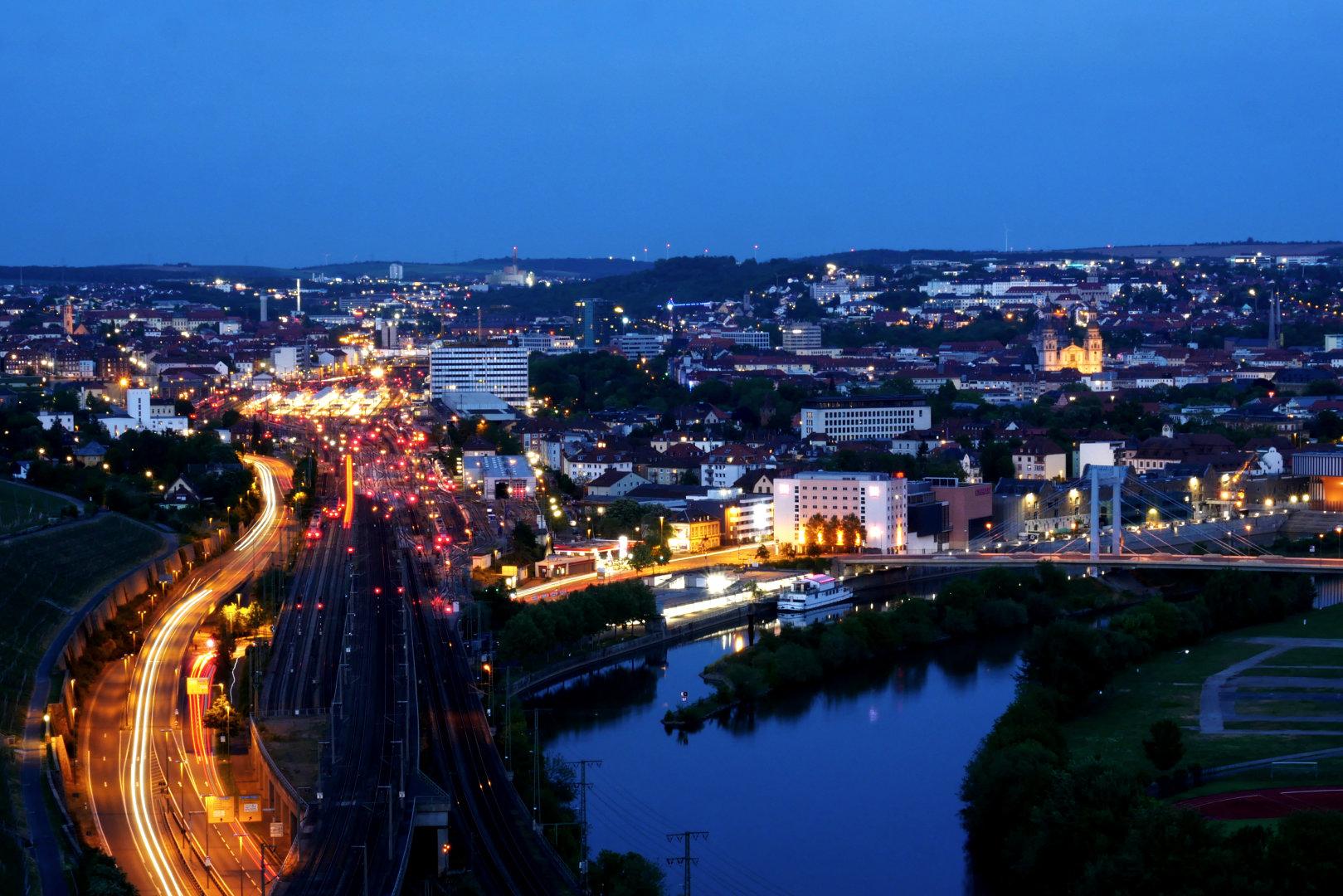 Würzburg train station, vineyards and Main river at dusk